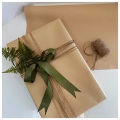 two wrapped presents with green ribbon and twine