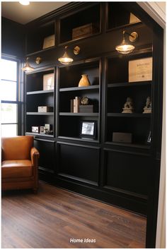 a chair and some bookshelves in a room with wood flooring on the walls