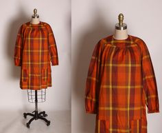 "1960's Orange, Brown and Yellow Plaid 3/4 Length Sleeve Pocketed Dress This dress features: *Orange, brown and yellow colors *Plaid print *3/4 length sleeve *Pocketed fronts Size: Large Measurements: Bust: 38\" Waist: 42\" Hip: 48\" Length: 35\" Condition: Excellent If you have any questions, please ask! Find even more Vintage Medium-Large at: https://www.etsy.com/shop/NaughtyKittyVintage?section_id=17605976&ref=shopsection_leftnav_9 Thanks! -NaughtyKittyVintage" Orange Plaid Dress, Orange And Black Plaid Skirt, Retro Plaid Cotton Dress, Retro Plaid Mini Dress, Orange Plaid, Yellow Plaid, Pocket Dress, Cool Hats, Dress Clothes For Women