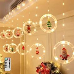 christmas decorations are hanging from the ceiling in front of a wall with lights and ornaments on it