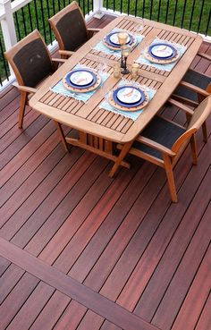 a wooden table and chairs on a deck