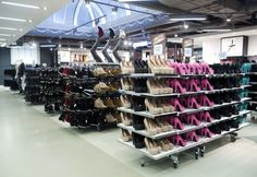 there are many pairs of women's shoes on display in the store, and one is for sale