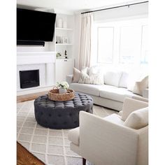 a living room filled with furniture and a flat screen tv mounted above the fire place