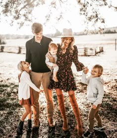 a family posing for a photo under a tree