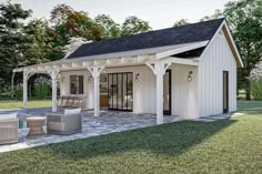 a small white shed sitting on top of a lush green field next to a swimming pool