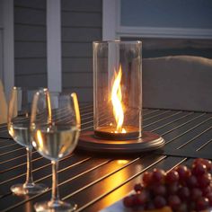 a table topped with wine glasses and a lit candle