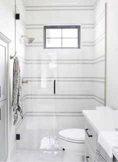 a bathroom with white walls and tile flooring