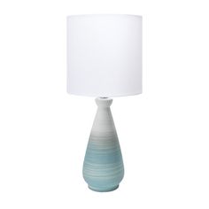 a blue and white lamp with a white shade on the top is sitting in front of a white background