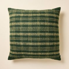 a green and white plaid pillow sitting on top of a wall