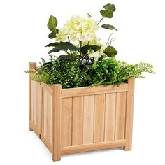 a wooden planter with white flowers and greenery in the bottom half, on a white background