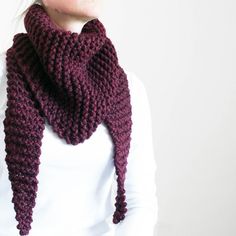 a woman wearing a purple knitted scarf