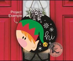 a door hanger with an elf's hat on it and the name project example