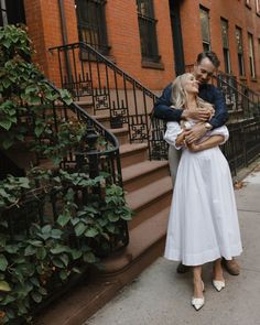 a man and woman embracing on the street