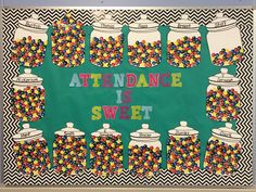 a bulletin board with candy in jars and the words attendance is sweet