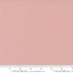 a pink background with a ruler in the foreground