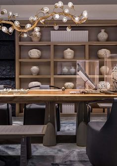 a dining room table with chairs and a chandelier