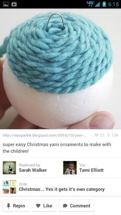 the yarn ball is being held by someone's hand, and it looks like they are