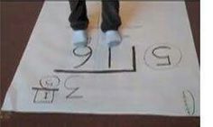 a person standing on top of a piece of paper with letters and numbers drawn on it