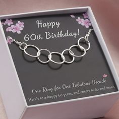 a birthday card in a box with three rings