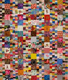 a colorful quilt with many different patterns on it