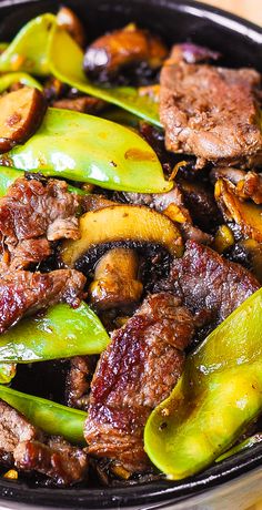 meat and vegetables in a pan on a table