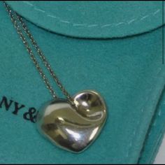 Tiffany And Co. Authentic Retired Vintage Puffed Heart Necklace Gently Worn Tiffany & Co. Necklace 16” Recently Polished By Tiffany And Co. *Includes New T&Co. Pouch, Box And Bag I Am Interested In Possible Trades As Well - I Will Consider Items Similarly Valued And Of Comparable Designer Names Puffed Heart Necklace, Designer Names, Puffed Heart, Designer Name, Tiffany Co Jewelry, Tiffany And Co, New T, Tiffany & Co., Heart Necklace