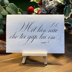 a white sign sitting on top of a wooden table