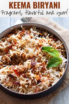 a bowl filled with rice and vegetables on top of a table