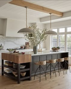 a large kitchen island with stools in front of it