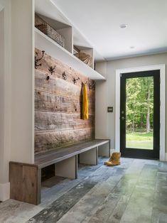 a wooden bench sitting in the middle of a room