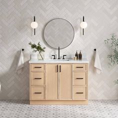 a bathroom vanity with two sinks and mirrors