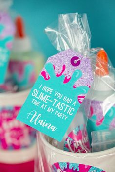 some plastic cups with candy in them and a sign that says i hope you had a slime - tastic time at my party