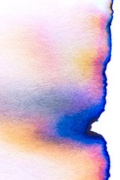 an abstract watercolor painting with blue, yellow and pink colors on the bottom right corner