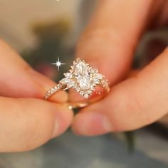 a person holding a diamond ring in their hand