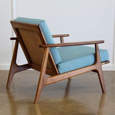 a blue chair sitting on top of a hard wood floor