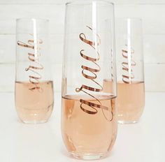 three wine glasses with the word love written on them