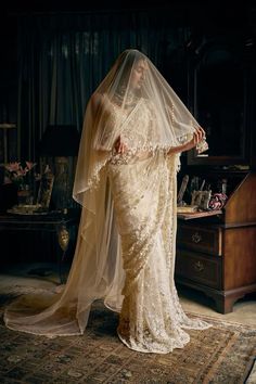 a woman in a wedding dress with a veil on her head