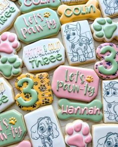 decorated cookies are arranged in the shape of dogs