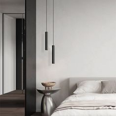 a white bed sitting next to a tall mirror on the side of a wall in a bedroom