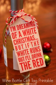 a bottle of wine with a tag on it that says i'm dreaming of a white christmas but if the white runs out i'll drink the red