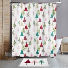 a shower curtain with trees on it in a bathroom