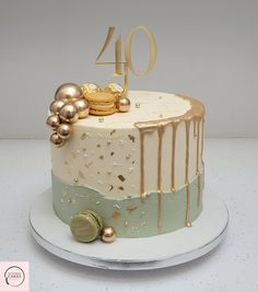 a cake decorated with gold and white icing