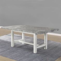 a white table sitting on top of a rug