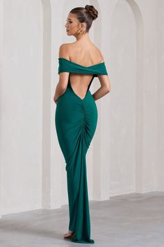 Sitting elegantly off the shoulders, our Vivienne maxi dress is the epitome of understated glamour. Arriving in a rich bottle green shade, Vivienne is defined by a contemporary open-back detail highlighted by flattering ruching. Completed with a godet-inspired train, try styling this maxi with some strappy stilettos for the perfect wedding guest look.  Features - Premium stretch jersey - Bardot neckline- Open back- Bum ruching - Godet-inspired drape- Maxi length Sizing & Fit Model is 5'7" and wears UK size 8 / US size 4 Product Information Designed exclusively by Club L London Double layered with good stretch Premium jersey in Bottle Green (95% Polyester, 5% Elastane) 140cm total length SKU: CL128862047 Sitting Elegantly, Midi Bridesmaid Dress, Open Back Maxi Dress, Black Dress Prom, Black Tie Gala, Strappy Stilettos, Wedding Guest Looks, Party Dress Long Sleeve, Bridesmaid Outfit