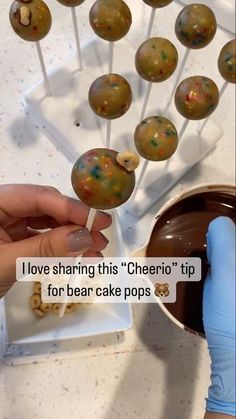 someone is decorating some cake pops with chocolate and sprinkles on them