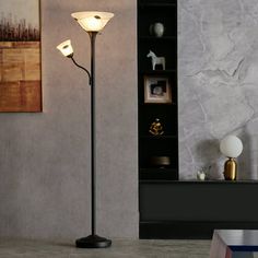 a lamp that is on top of a table next to a book shelf and bookshelf