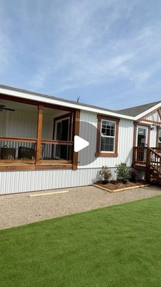 a mobile home is shown with grass in the foreground