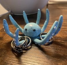 an octopus figurine sitting on top of a wooden table