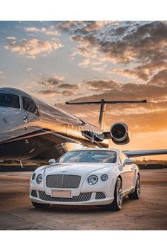 a white bentley parked in front of an airplane