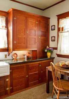 a kitchen with wooden cabinets and black counter tops in the middle of an instagram page